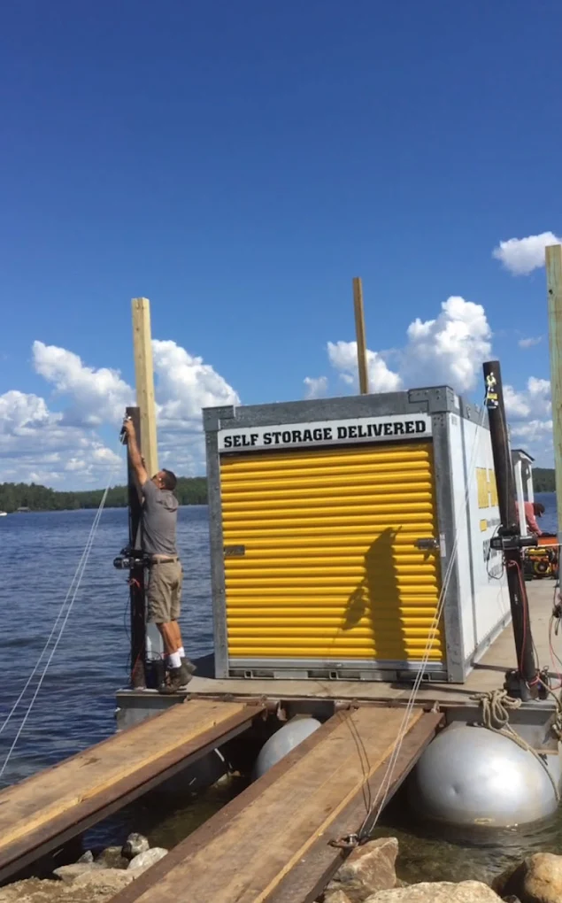 MI-BOX portable storage container loaded onto a barge for delivery to a Lake Winnipesaukee island