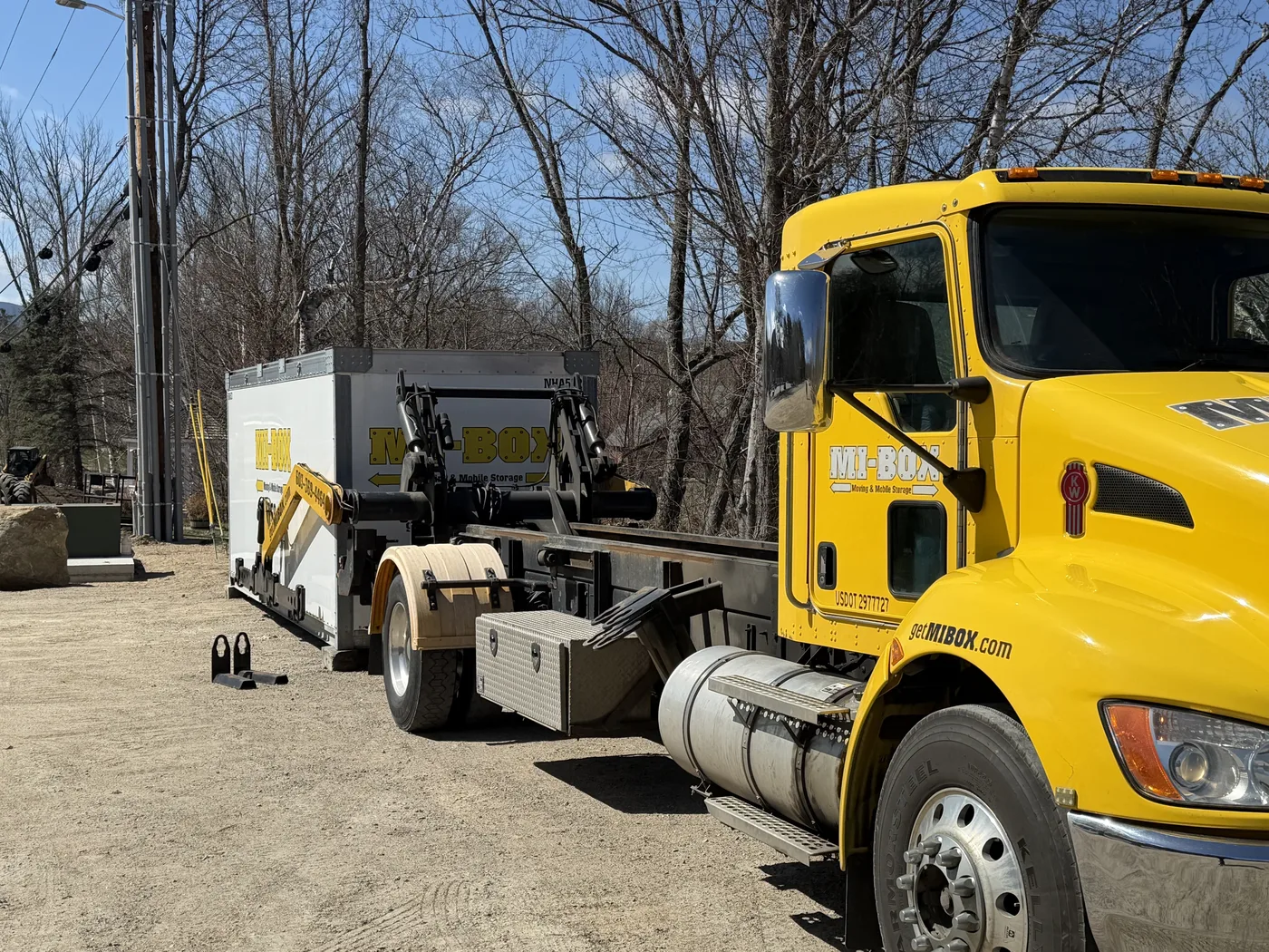 MI-BOX driver placing a portable storage container at a New Hampshire jobsite
