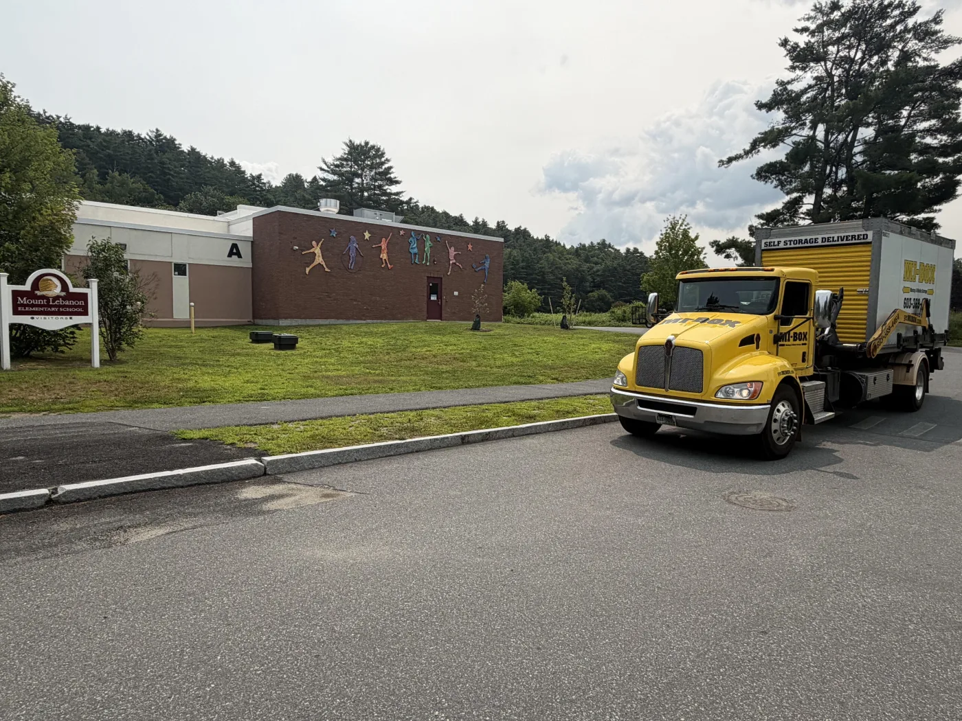 MI-BOX portable storage delivery truck in a Lebanon NH neighborhood