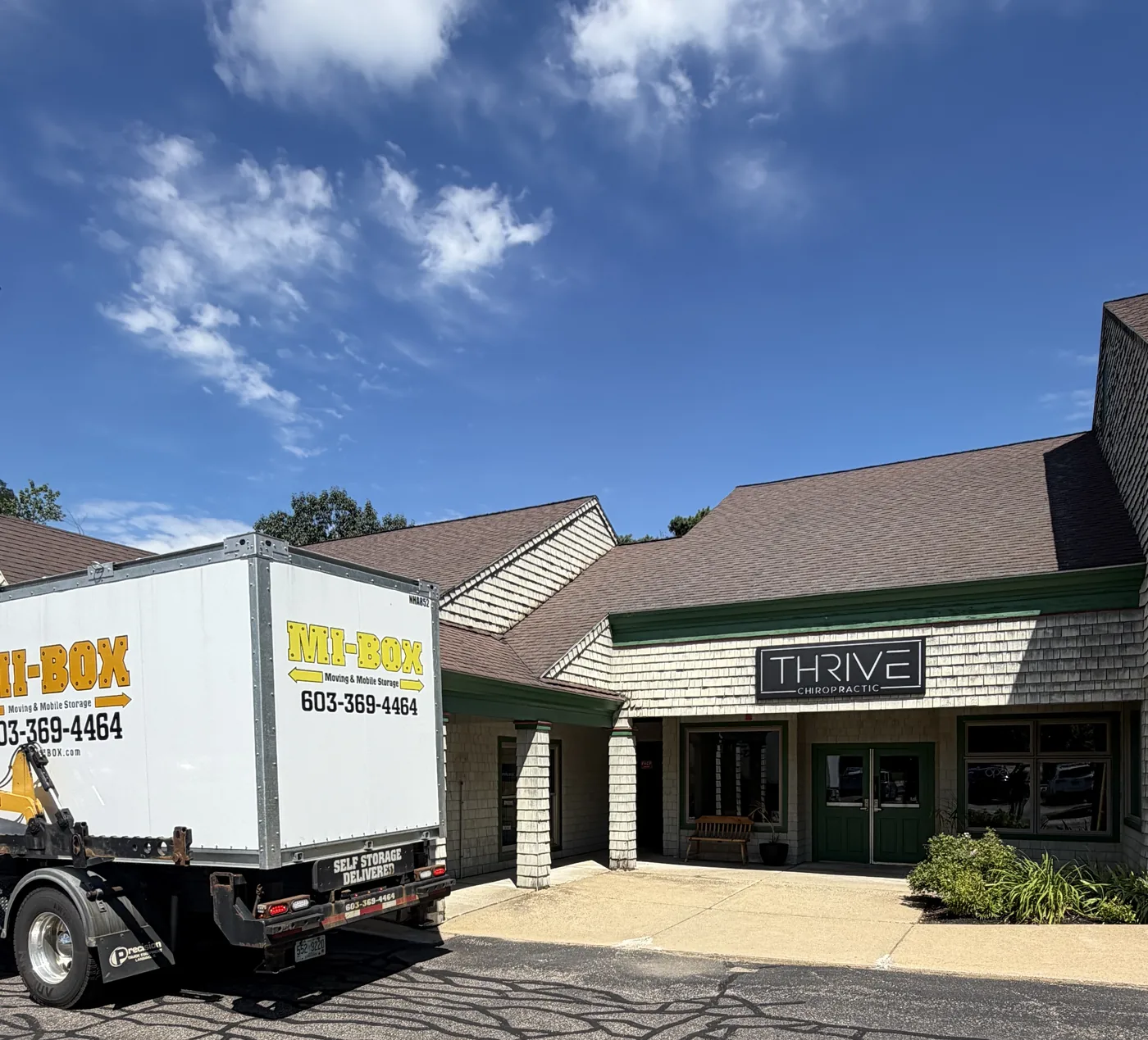 MI-BOX portable storage delivery truck outside Thrive Chiropractic in New Hampshire