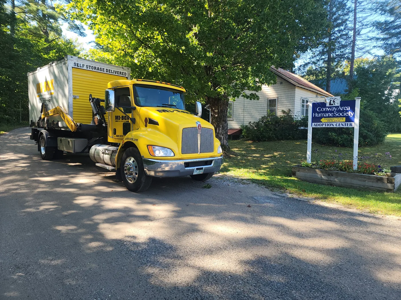 MI-BOX truck delivering a portable storage container at the Conway Area Humane Society adoption center in North Conway NH